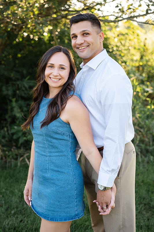 Hopeful adoptive parents Ben and Annamarie stand together for aa photo outdoors