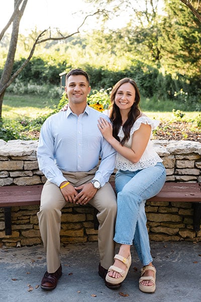 hopeful adoptive couple sitting on a bench outside