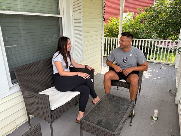 happy couple sitting together on their porch